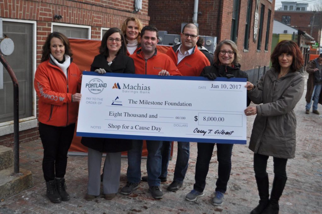 Milestone Foundation receiving a check from Shop for a Cause proceeds